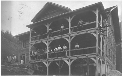 Im Jahr 1910 wurde das Wirtschaftsgebäude um einen Stock erhöht und die imposante Veranda gebaut.jpg